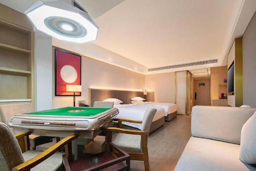 Ένα ή περισσότερα κρεβάτια σε δωμάτιο στο Echeng Hotel Enshi Minzu Road