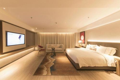 Ένα ή περισσότερα κρεβάτια σε δωμάτιο στο Echeng Hotel Enshi Minzu Road