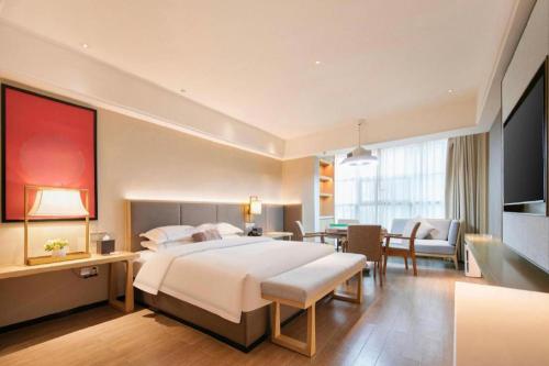 Ένα ή περισσότερα κρεβάτια σε δωμάτιο στο Echeng Hotel Enshi Minzu Road
