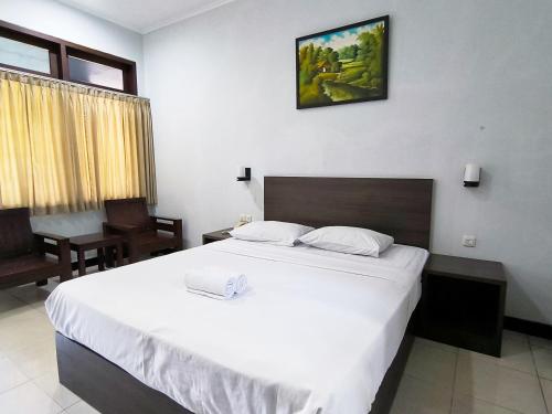 a bedroom with a large white bed in a room at Wisma Griyaku 1 in Purbolinggo