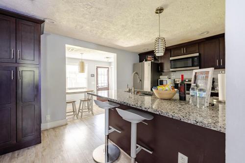 a kitchen with a counter with stools in it at The Little Blue Haus - Two Miles to Broadway in Nashville