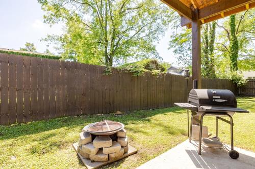 a grill in a yard next to a fence at The Little Blue Haus - Two Miles to Broadway in Nashville