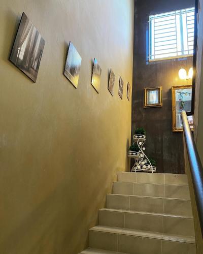 a hallway with stairs with pictures on the wall at The Deck Homestay & Event House in Jitra