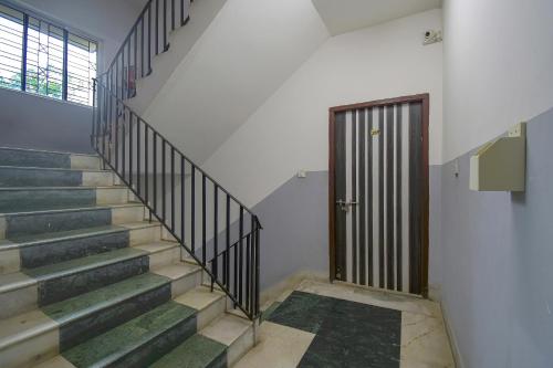 a staircase with a door in a building at Collection O Bricks Inn Hazra Road Near Birla Mandir in Ballygunge