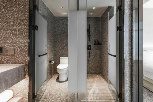 a bathroom with a toilet and a shower and a tub at Airfeel Hotel in Ziyang