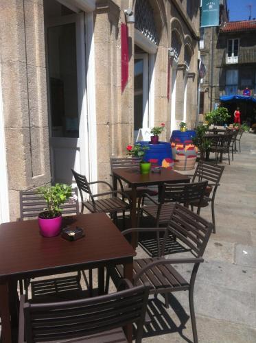 a row of tables and chairs on a patio at Hotel Pazo de Altamira in Santiago de Compostela