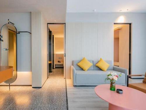 a living room with a couch and a table at Airfeel Hotel in Ziyang