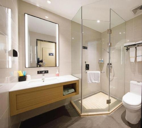 a bathroom with a shower and a sink and a toilet at City Comfort Inn Wuhan Yangtze River Bridge Yellow Crane Tower in Wuhan