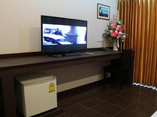 a television sitting on a desk in a room at The Grace Residence in Surin