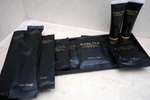 a group of black products sitting on a counter at Karlita Hotel Tegal in Tegal