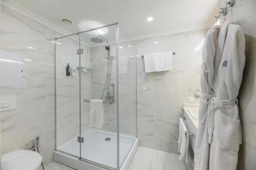 a bathroom with a shower and a toilet at Almaty Hotel in Almaty