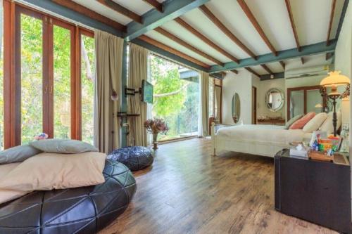 a bedroom with two beds and a large window at Villa Moreeda in Thung Faek