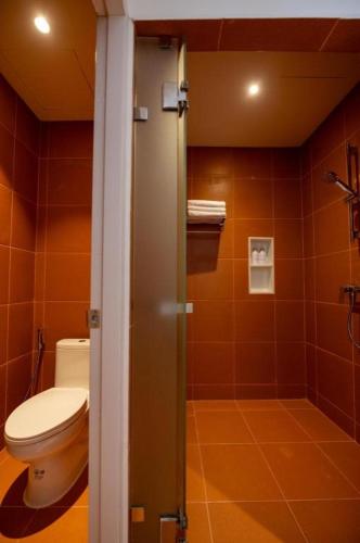 a bathroom with a toilet and a shower at 777Bliss Hometel in Nakhon Phanom