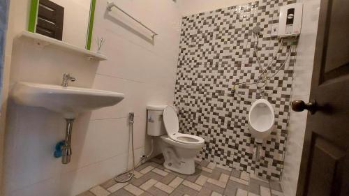a bathroom with a toilet and a sink at Ban Naam Resort in Mae Sai