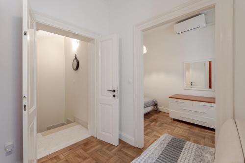 a bathroom with a white door and a mirror at Villa Palo Alto in Dubrovnik