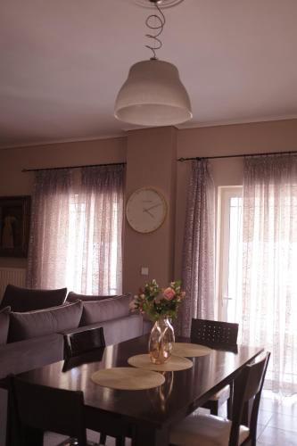a dining room with a table and a couch at Anastasia's Rooms in Mytilini