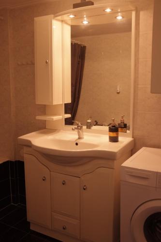a bathroom with a white sink and a mirror at Anastasia's Rooms in Mytilini