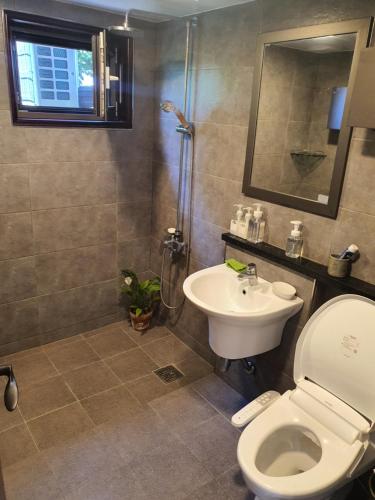 a bathroom with a toilet and a sink at Samojeong, Jeju in Jeju