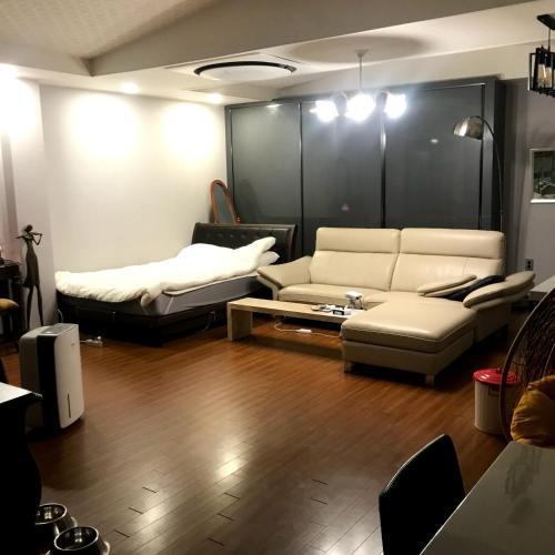 a living room with a couch and a bed at Samojeong, Jeju in Jeju