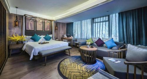a hotel room with a bed and a couch at Grand Holiday Hotel in Shenzhen