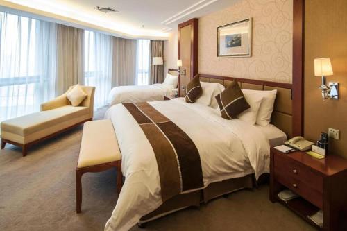 Postel nebo postele na pokoji v ubytování Xian Qujiang Yinzuo Hotel