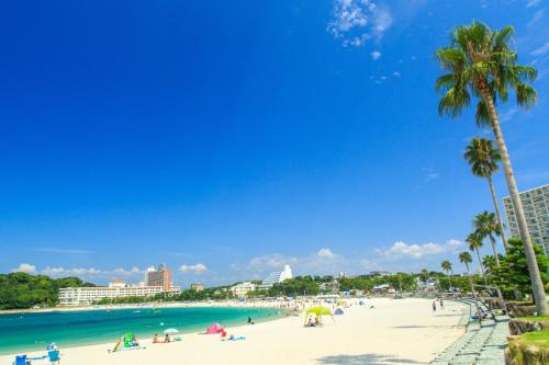 a group of people on a beach with palm trees at TAOYA Shirahama Senjyo in Shirahama