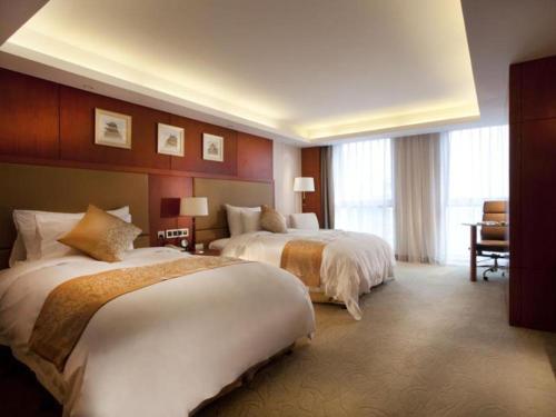 Postel nebo postele na pokoji v ubytování Xian Qujiang Yinzuo Hotel