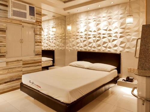 a bedroom with a large bed in a room at One Serenata Hotel General Trias in Silang