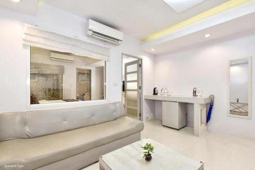 a living room with a couch and a table at NanNakara Boutique Hotel in Nan