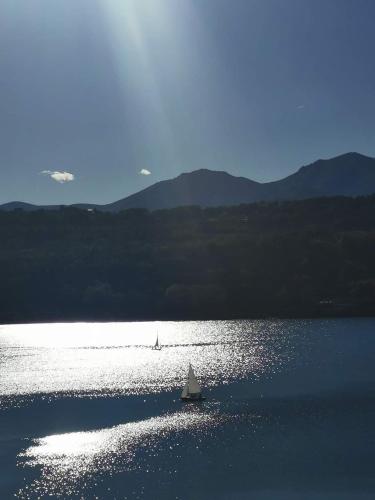 a small boat in the middle of a lake at Antica Quercia Apartment in Avigliana