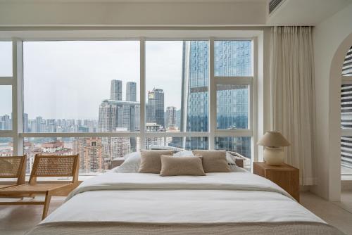 a bedroom with a large bed and a large window at Guyu B&B in Chongqing