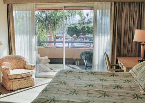 une chambre avec un lit et une vue sur un balcon dans l'établissement Marquis Villas Resort, à Palm Springs