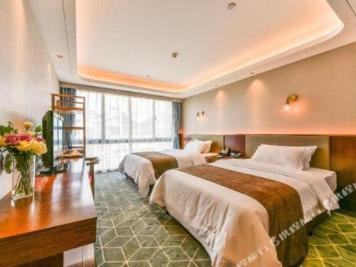 Ένα ή περισσότερα κρεβάτια σε δωμάτιο στο Guilin Plaza Hotel