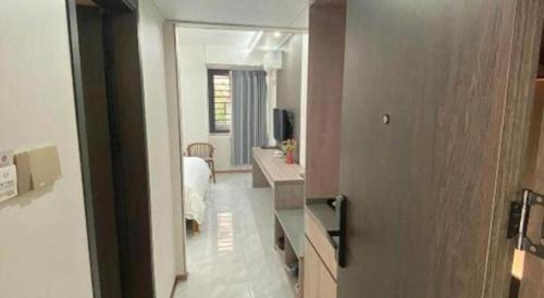 a bedroom with a bed and a desk in a room at Movie Star Hotel in Guangzhou