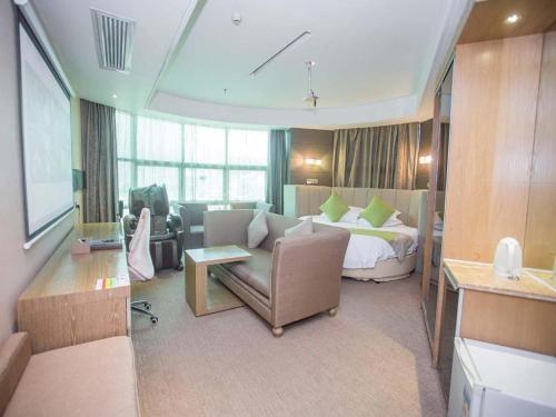 a hotel room with a bed and a living room at GreenTree Alliance Shenzhen Shekou Sea World Hotel in Shenzhen