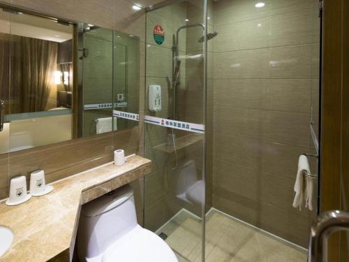 a bathroom with a shower and a toilet and a sink at GreenTree Alliance Shenzhen Shekou Sea World Hotel in Shenzhen