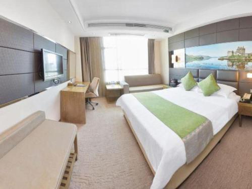 a hotel room with a large bed and a television at GreenTree Alliance Shenzhen Shekou Sea World Hotel in Shenzhen