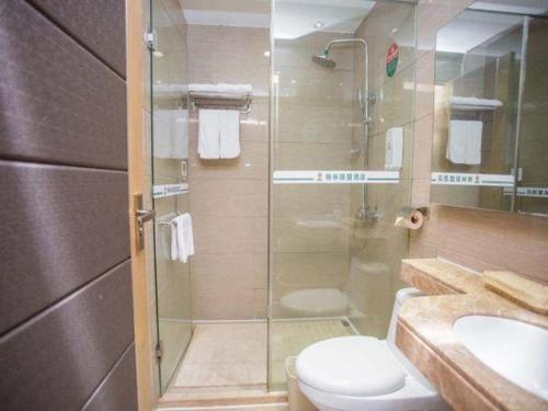 a bathroom with a shower and a toilet and a sink at GreenTree Alliance Shenzhen Shekou Sea World Hotel in Shenzhen