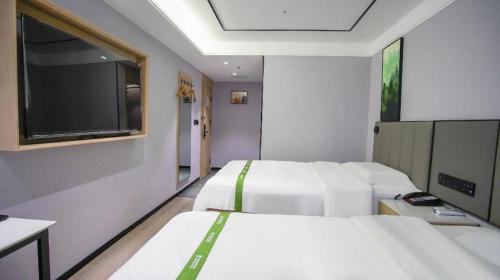 Ένα ή περισσότερα κρεβάτια σε δωμάτιο στο GreenTree Inn LiaoCheng LinQing HaiShan Building Express Hotel