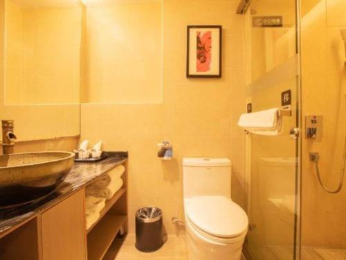 a bathroom with a toilet and a sink at Chambery Hotel in Zhuhai