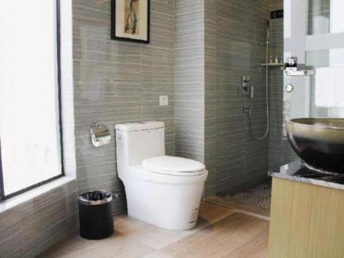 a bathroom with a toilet and a sink at Chambery Hotel in Zhuhai