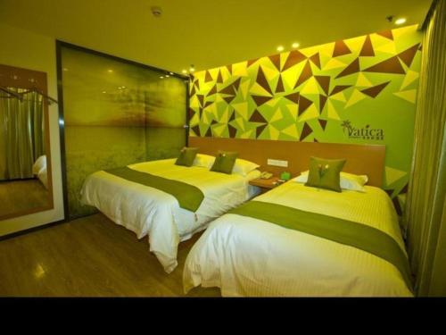 a bedroom with two beds in a room at Vatica Beijing Tongzhou Liyuan Universal Studios in Beijing