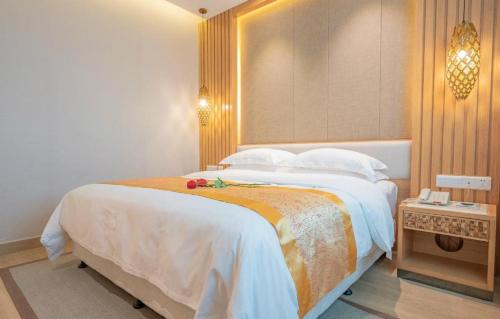 a bedroom with a large bed in a room at Excemon Beach Hotel Beihai in Beihai