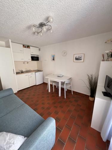 a living room with a couch and a table at Appartement au cœur de Bandol in Bandol