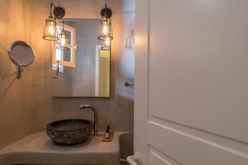 a bathroom with a sink and a mirror at Cova Mykonos Suites in Elia Beach