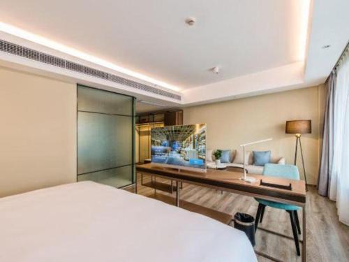 a hotel room with a bed and a desk at AURAYA BY SUNING NANJING XUZHUANG in Nanjing