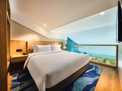Ένα ή περισσότερα κρεβάτια σε δωμάτιο στο Emerald Bay Hotel