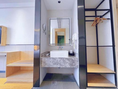 a bathroom with a sink and a mirror at GreenTree Inn Nanjing Baijiahu in Nanjing