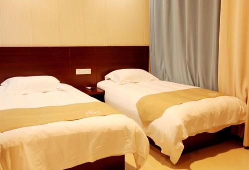 Katil atau katil-katil dalam bilik di Shell Zaozhuang Taierzhuang Ancient City East Gate Hotel