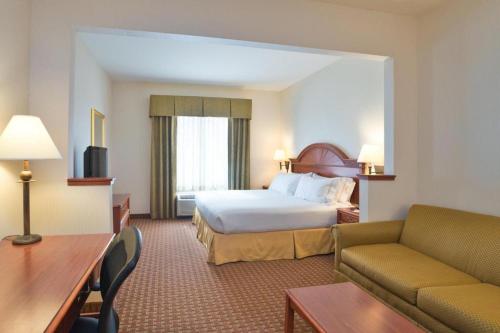a hotel room with a bed and a couch at Holiday Inn Express Frackville Hotel By IHG in Frackville